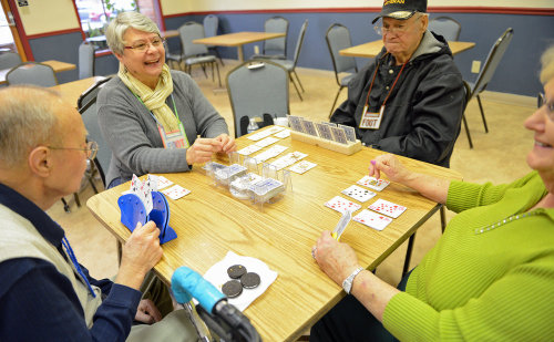 Senior friends enjoying a game of cards at Comal County Senior Citizens Fdn
